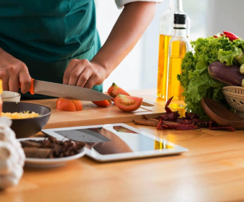 man slicing a cucumber